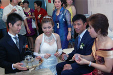 After the wedding ceremony, the bride serves tea to the groom's parents. Photo courtesy of Ms. Zyndee Co After the wedding ceremony, the bride serves tea to the groom's parents. Photo courtesy of Ms. Zyndee Co